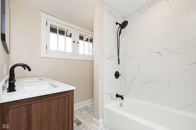 bathroom with tiled shower / bath combo and vanity