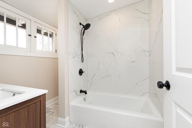 bathroom with vanity and tiled shower / bath