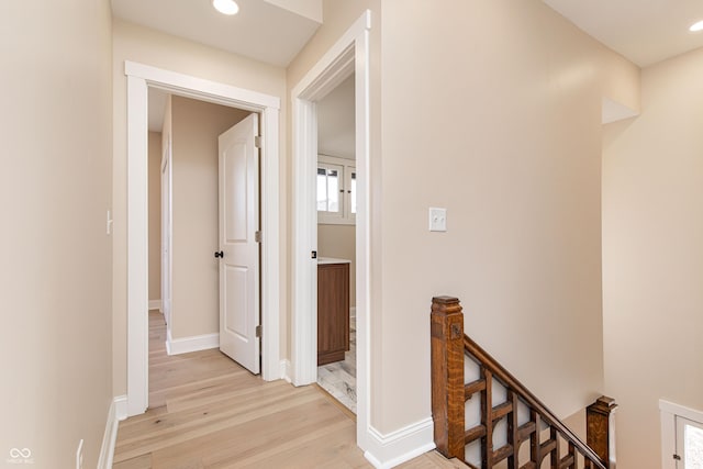 corridor with light hardwood / wood-style floors