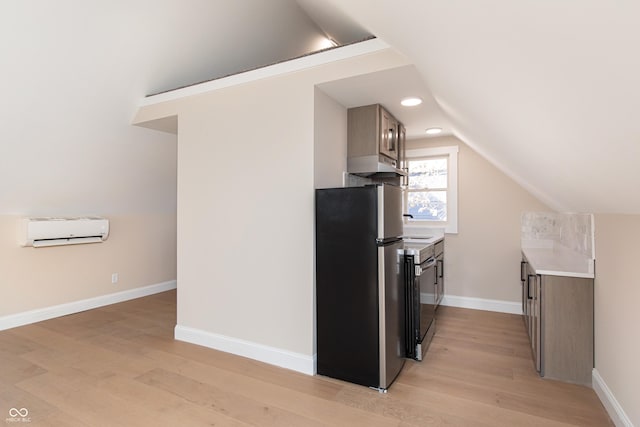 kitchen with lofted ceiling, a wall mounted air conditioner, stainless steel fridge, and light hardwood / wood-style floors