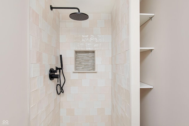 bathroom with a tile shower