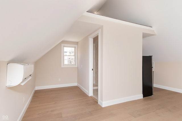 bonus room with lofted ceiling and light hardwood / wood-style floors