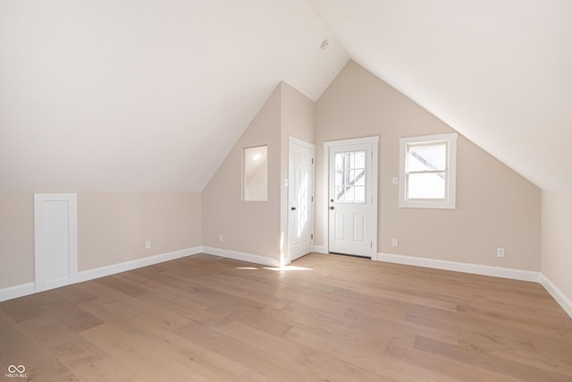 bonus room featuring lofted ceiling and light wood-type flooring