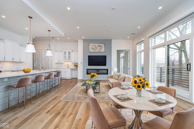 dining room with light wood-type flooring and recessed lighting