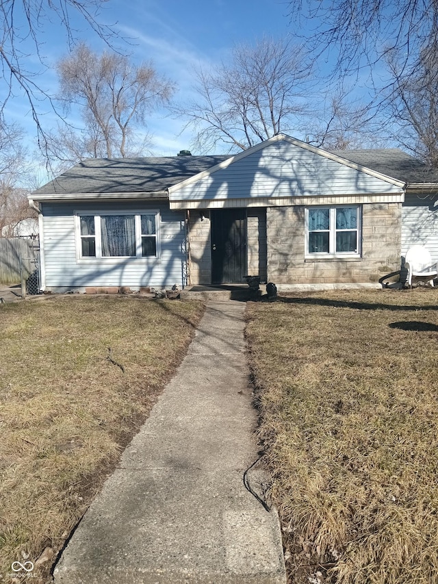 ranch-style house featuring a front lawn