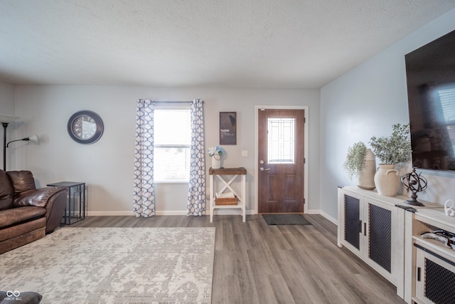 entryway featuring hardwood / wood-style floors and a textured ceiling