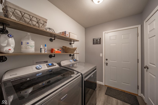 laundry room featuring dark hardwood / wood-style flooring and washer and clothes dryer