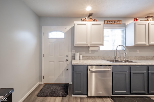 kitchen featuring sink, gray cabinets, dishwasher, hardwood / wood-style flooring, and white cabinets