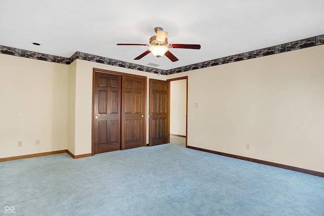 unfurnished bedroom with a closet, ceiling fan, and carpet