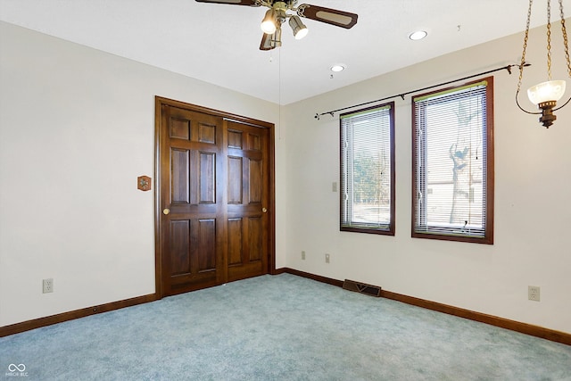 unfurnished bedroom with carpet flooring and ceiling fan