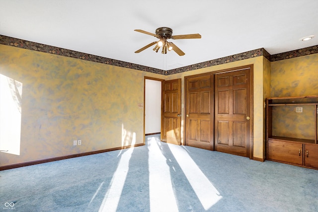 unfurnished bedroom with light colored carpet, ceiling fan, and a closet