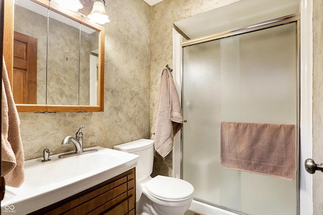 bathroom with vanity, an enclosed shower, and toilet