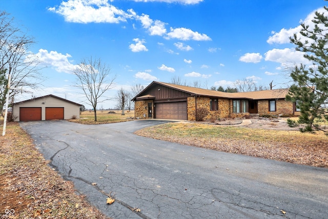 single story home with a garage and an outdoor structure