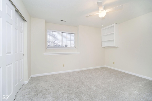 unfurnished bedroom featuring a closet, ceiling fan, and light colored carpet