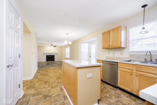 kitchen featuring sink, stainless steel dishwasher, a center island, and decorative light fixtures