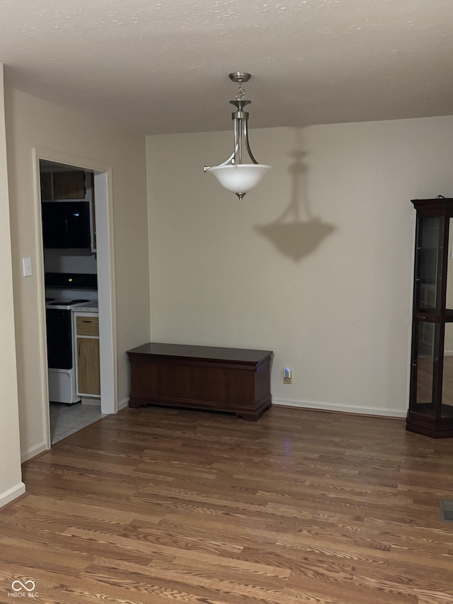 unfurnished dining area with dark hardwood / wood-style floors