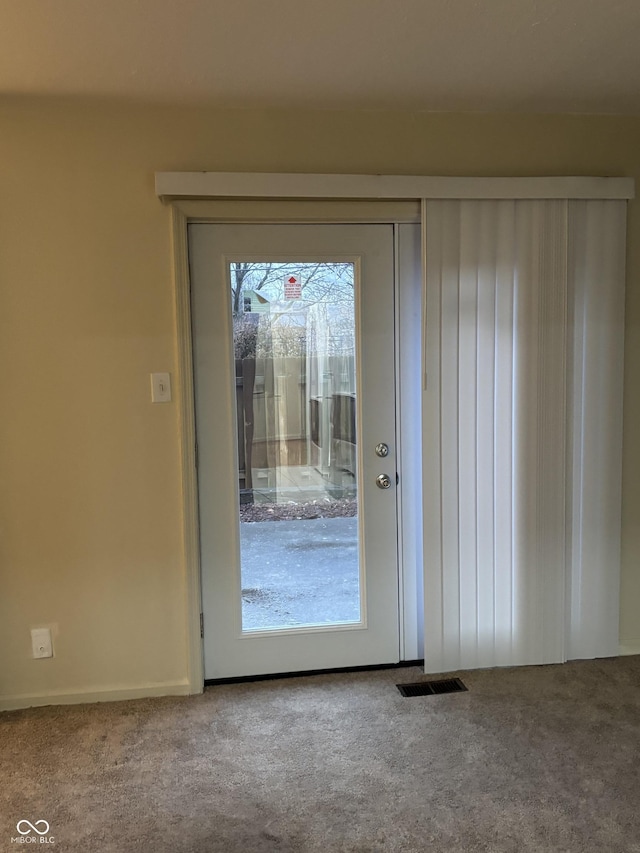 doorway to outside with carpet floors