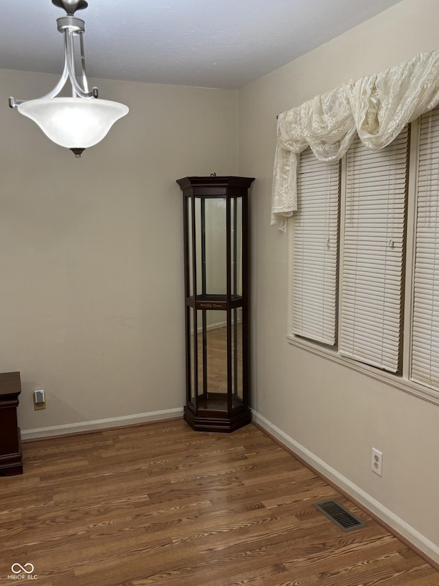 unfurnished dining area featuring dark hardwood / wood-style floors