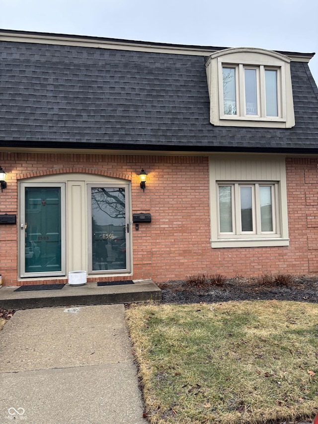 entrance to property featuring a lawn