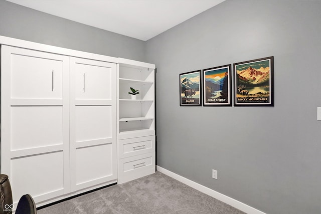 unfurnished bedroom featuring light carpet and a closet