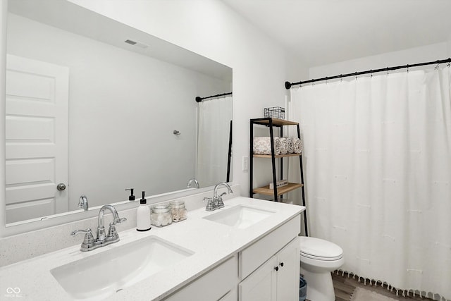 bathroom featuring vanity and toilet