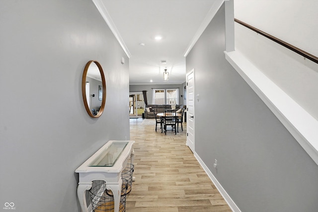 hallway featuring light hardwood / wood-style flooring and ornamental molding