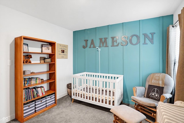 bedroom with a crib and light colored carpet