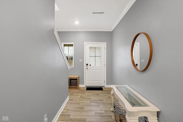 entrance foyer with light hardwood / wood-style flooring and ornamental molding