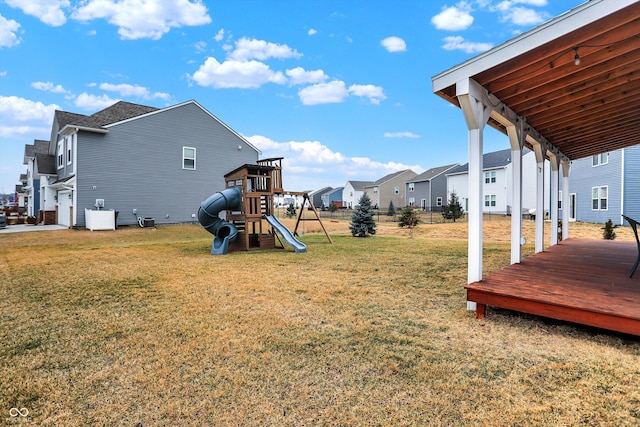 view of yard featuring a wooden deck, central AC, and a playground