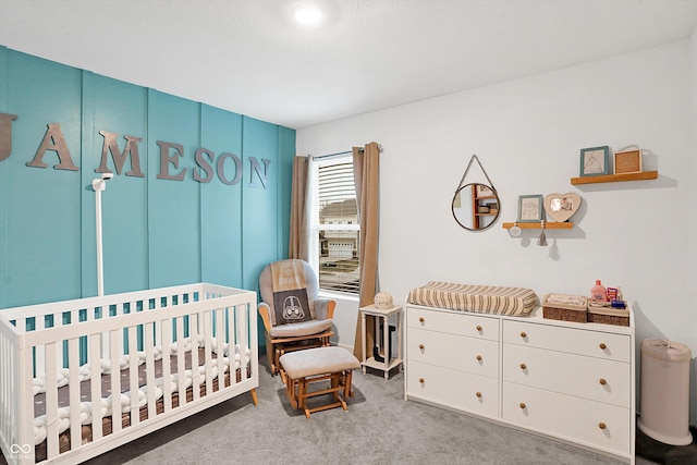 carpeted bedroom featuring a crib