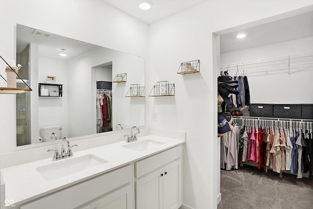 bathroom featuring vanity and toilet