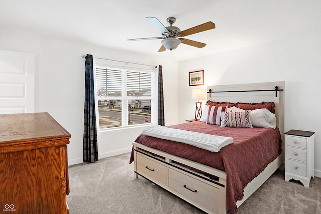 bedroom featuring light colored carpet and ceiling fan