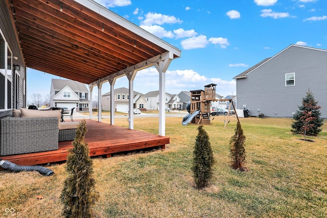 view of yard featuring a wooden deck and a playground