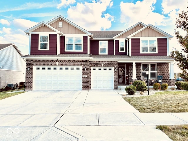 craftsman inspired home featuring board and batten siding, brick siding, and driveway