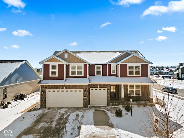 multi unit property with a garage, brick siding, and board and batten siding