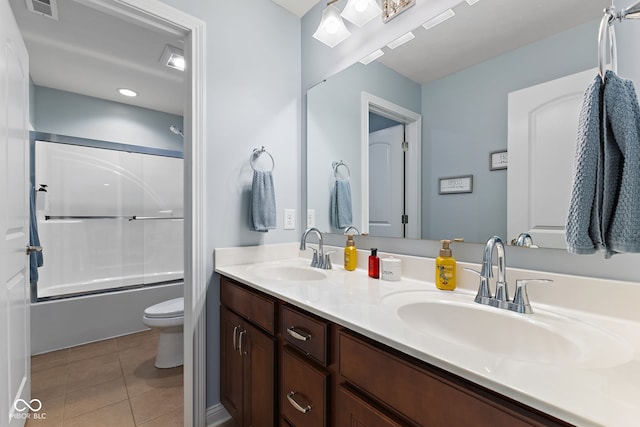 full bathroom with toilet, visible vents, a sink, and tile patterned floors