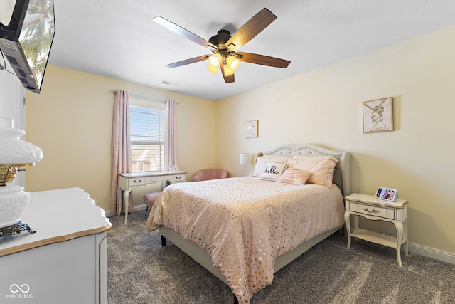 bedroom featuring baseboards, visible vents, dark carpet, and a ceiling fan