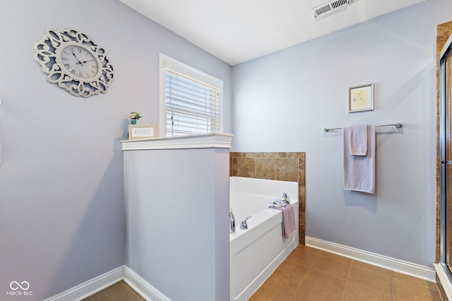 full bath with visible vents, tile patterned floors, a bath, and baseboards