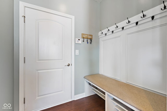 mudroom with dark wood-style flooring and baseboards