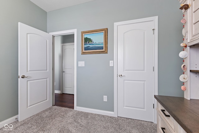 unfurnished bedroom featuring carpet flooring and baseboards