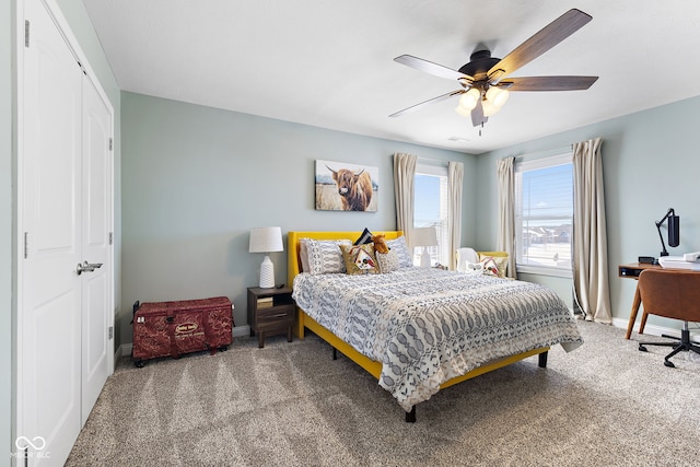 bedroom featuring carpet floors, a ceiling fan, and baseboards