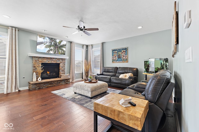 living room featuring recessed lighting, a fireplace, wood finished floors, a ceiling fan, and baseboards