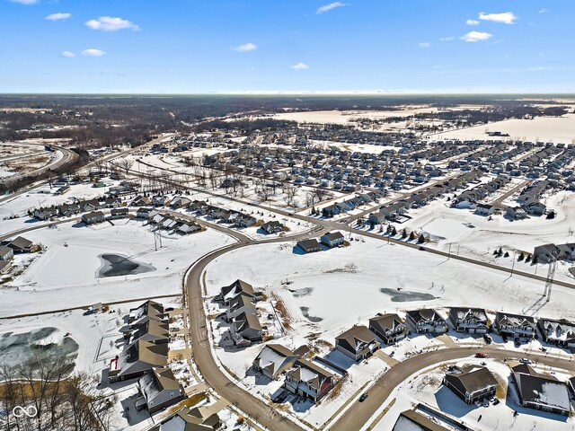 snowy aerial view featuring a residential view