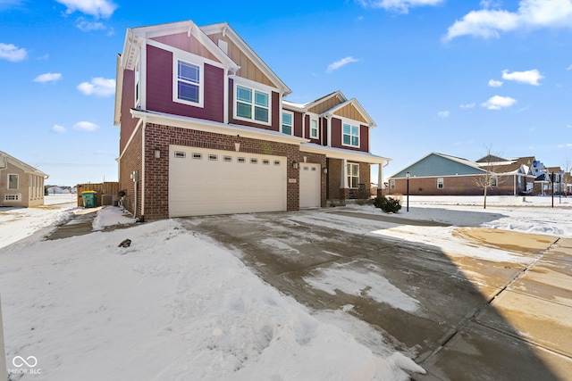 view of front of property featuring a garage, driveway, brick siding, and board and batten siding