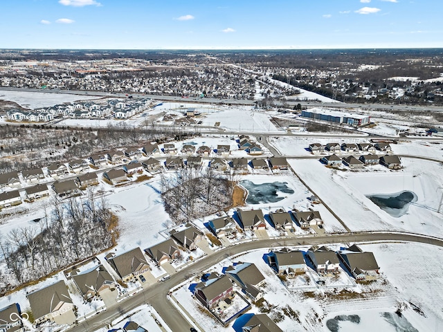 snowy aerial view featuring a residential view