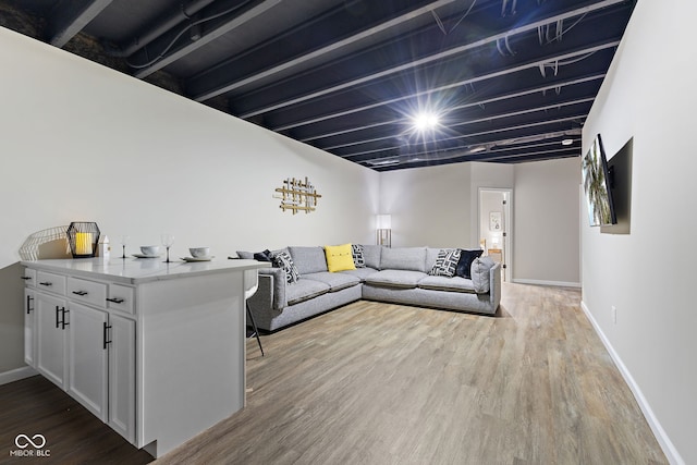 living room with baseboards and wood finished floors