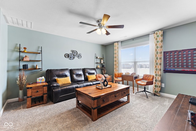 living room featuring a ceiling fan, carpet, visible vents, and baseboards