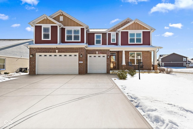 view of front of property with a garage, board and batten siding, and brick siding