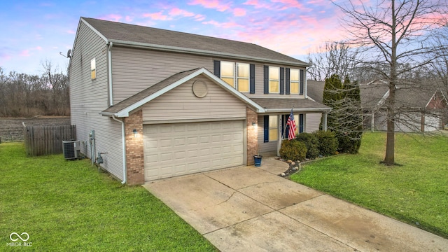 traditional-style house with cooling unit, a garage, brick siding, concrete driveway, and a lawn