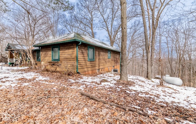 snow covered property featuring cooling unit